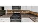 Close up of updated kitchen with stainless steel microwave and range plus decorative tile backsplash at 2165 Capella Cir, South Fulton, GA 30331