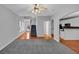 Open-concept living space with stairs, adjacent dining area, and view of kitchen with breakfast bar at 2165 Capella Cir, South Fulton, GA 30331