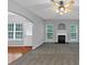 Open-concept living room features a fireplace, neutral gray walls, and an abundance of natural light at 2165 Capella Cir, South Fulton, GA 30331