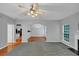 Spacious open-concept living area with fireplace, ceiling fan, and view of the dining area and kitchen at 2165 Capella Cir, South Fulton, GA 30331