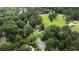 Aerial view of a neighborhood surrounded by mature trees and lush greenery at 4188 Kindlewood Ne Ct, Roswell, GA 30075
