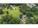 Lush, verdant neighborhood, showcasing tree canopy, a pond, and beautiful homes at 4188 Kindlewood Ne Ct, Roswell, GA 30075