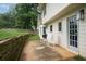 Charming back patio featuring rocking chairs, lush lawn, and tranquil outdoor space at 4188 Kindlewood Ne Ct, Roswell, GA 30075