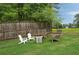Fire pit area with chairs in a spacious backyard, great for outdoor entertaining and relaxation at 4188 Kindlewood Ne Ct, Roswell, GA 30075