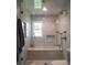 Bathroom featuring a glass enclosed shower and tub with modern fixtures at 4188 Kindlewood Ne Ct, Roswell, GA 30075