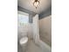 A bathroom featuring a toilet, tub and shower combo with white subway tile at 4188 Kindlewood Ne Ct, Roswell, GA 30075