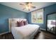 A bedroom features wood floors, white bedding, and a view of the back yard at 4188 Kindlewood Ne Ct, Roswell, GA 30075