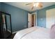 A bedroom with blue walls, wood floors, and a large mirror at 4188 Kindlewood Ne Ct, Roswell, GA 30075