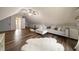 Cozy bonus room with wood floors, ceiling fan, and comfortable seating area with plush, white rug at 4188 Kindlewood Ne Ct, Roswell, GA 30075