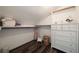 A closet with wood floor, shelves, clothing rack, and a set of drawers at 4188 Kindlewood Ne Ct, Roswell, GA 30075
