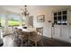 Cozy dining room with large windows overlooking the yard and a white wooden table at 4188 Kindlewood Ne Ct, Roswell, GA 30075