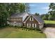 Beautiful two-story brick home with manicured lawn and mature trees at 4188 Kindlewood Ne Ct, Roswell, GA 30075