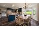 Eat-in kitchen featuring navy cabinets, island, stainless appliances and backyard views at 4188 Kindlewood Ne Ct, Roswell, GA 30075