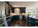 Modern kitchen with stainless steel appliances, dark blue cabinets, hardwood floors and a view of the backyard at 4188 Kindlewood Ne Ct, Roswell, GA 30075