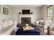 Bright living room featuring a fireplace, sofa, and comfortable armchairs at 4188 Kindlewood Ne Ct, Roswell, GA 30075