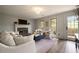 Inviting living room with cozy fireplace, French doors and neutral color palette at 4188 Kindlewood Ne Ct, Roswell, GA 30075