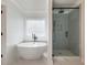 Modern bathroom featuring a freestanding tub and glass shower at 4436 Hosch Reserve Ct, Buford, GA 30519