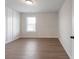 Well-lit bedroom with wood floors and bright window at 4436 Hosch Reserve Ct, Buford, GA 30519