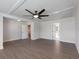 Large bedroom featuring a tray ceiling with a modern ceiling fan and open doorways at 4436 Hosch Reserve Ct, Buford, GA 30519
