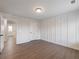 Well-lit bedroom showcasing decorative wall paneling and an open doorway to another room at 4436 Hosch Reserve Ct, Buford, GA 30519