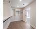 Walk-in closet with custom shelving located adjacent to the primary bathroom at 4436 Hosch Reserve Ct, Buford, GA 30519