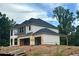 Two-story home under construction with an attached 2-car garage and unfinished yard at 4436 Hosch Reserve Ct, Buford, GA 30519