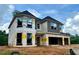 Two-story home under construction with an attached 2-car garage and unfinished yard at 4436 Hosch Reserve Ct, Buford, GA 30519