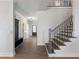Grand foyer featuring a staircase with decorative metal railing and an entryway coat rack at 4436 Hosch Reserve Ct, Buford, GA 30519