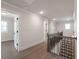 Upstairs hallway featuring wooden banister at 4436 Hosch Reserve Ct, Buford, GA 30519