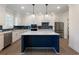 Spacious kitchen with navy island, stainless appliances, and white cabinetry at 4436 Hosch Reserve Ct, Buford, GA 30519