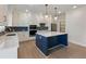 Open kitchen with a navy island, white countertops, stainless appliances, and wood flooring at 4436 Hosch Reserve Ct, Buford, GA 30519