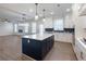 Open kitchen features a large island, white cabinets, and stainless appliances at 4436 Hosch Reserve Ct, Buford, GA 30519