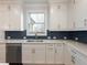 Bright kitchen with white cabinets, stainless steel appliances, and subway tile backsplash at 4436 Hosch Reserve Ct, Buford, GA 30519