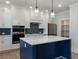 Spacious kitchen with navy island, stainless appliances, and ample storage at 4436 Hosch Reserve Ct, Buford, GA 30519