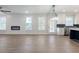 Bright living room with a modern fireplace and open floor plan connected to the kitchen at 4436 Hosch Reserve Ct, Buford, GA 30519