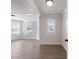 Bright living room with large windows, modern lighting, and neutral decor at 4436 Hosch Reserve Ct, Buford, GA 30519