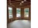 Unfinished room with exposed wood framing, three windows, and natural light at 4436 Hosch Reserve Ct, Buford, GA 30519