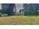 Spacious backyard with a view of the trees and a house in the distance at 1102 Tony Valley Dr, Conyers, GA 30013