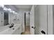 Clean bathroom featuring light wood floors, white vanity, and black matte hardware at 1102 Tony Valley Dr, Conyers, GA 30013