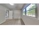 Bright bedroom with neutral paint, carpet, and large windows with a view of the outdoors at 1102 Tony Valley Dr, Conyers, GA 30013