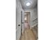 Hallway features neutral walls, wood-look floors and access to upper levels via a carpeted staircase at 1102 Tony Valley Dr, Conyers, GA 30013
