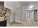 Cozy living area with stone fireplace, wood floors, and soft, neutral wall color at 1102 Tony Valley Dr, Conyers, GA 30013