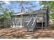 Backyard with deck, exterior of two story home with gray siding and mature trees at 2106 Singer Way, Lithonia, GA 30058