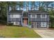 Charming two-story home with gray siding, mature trees, and a welcoming entrance at 2106 Singer Way, Lithonia, GA 30058