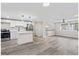 Open-concept kitchen featuring white cabinets and stainless steel appliances next to a living area at 2106 Singer Way, Lithonia, GA 30058