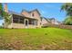 Grassy backyard featuring a screened in porch, ideal for relaxing at 2428 Harmony Ridge Ct, Lithonia, GA 30058