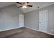 Neutral bedroom featuring a vaulted ceiling, ceiling fan, plush carpeting, and bright white doors at 2428 Harmony Ridge Ct, Lithonia, GA 30058