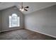 Spacious bedroom featuring a vaulted ceiling, ceiling fan, plush carpeting, and a window with neighborhood views at 2428 Harmony Ridge Ct, Lithonia, GA 30058
