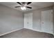 Carpeted bedroom featuring neutral walls, ceiling fan and a double-door closet at 2428 Harmony Ridge Ct, Lithonia, GA 30058