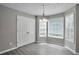 Charming breakfast nook with lots of natural light from three windows and a modern chandelier at 2428 Harmony Ridge Ct, Lithonia, GA 30058